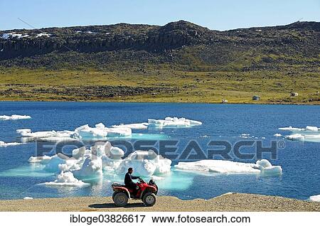 "Man of the Inuit people riding a quad bike, ATM, parked on the shore of the Beaufort Sea, Arctic Ocean, Victoria Island, formerly Holman Island, village of Ulukhaktok, Northwest Territories, Canada, North America" View Large Photo Image Stock Photo - "Man of the Inuit people riding a quad bike, ATM, parked on the shore of the Beaufort Sea, Arctic Ocean, Victoria Island, formerly Holman Island, village of Ulukhaktok, Northwest Territories, Canada, North America". Fotosearch