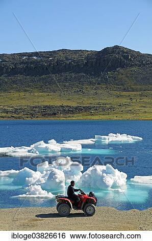 "Man of the Inuit people riding a quad bike, ATM, parked on the shore of the Beaufort Sea, Arctic Ocean, Victoria Island, formerly Holman Island, village of Ulukhaktok, Northwest Territories, Canada, North America" View Large Photo Image Stock Photograph - "Man of the Inuit people riding a quad bike, ATM, parked on the shore of the Beaufort Sea, Arctic Ocean, Victoria Island, formerly Holman Island, village of Ulukhaktok, Northwest Territories, Canada, North America". Fotosearch