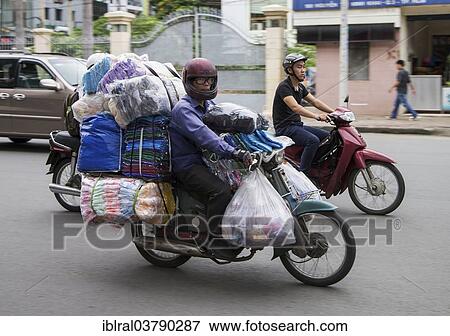 Stock Photo - "Man on a packed bike, Ho Chi Minh City, Vietnam, Asia". Fotosearch