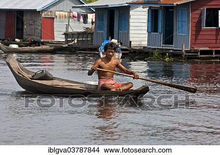 "Man paddling a boat near a floating village on Tonle Sap Lake, near Siem Reap, Cambodia, Asia" View Large Photo Image Picture - "Man paddling a boat near a floating village on Tonle Sap Lake, near Siem Reap, Cambodia, Asia". Fotosearch