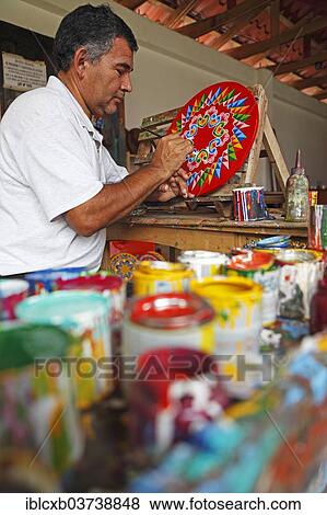 Stock Photo - "Man painting the hub of a traditional oxcart or Carreta, Sarchi, Alajuela province, Costa Rica, North America". Fotosearch