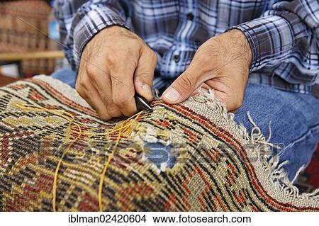 Man patching a carpet, Sultanahmet historic district, Istanbul, Turkey, Europe, Asia View Large Photo Image Picture - Man patching a carpet, Sultanahmet historic district, Istanbul, Turkey, Europe, Asia. Fotosearch