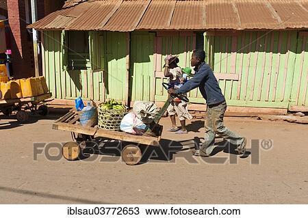 "Man pushes goods on a home-made cart, Ambalavao, Madagascar, Africa" View Large Photo Image Stock Image - "Man pushes goods on a home-made cart, Ambalavao, Madagascar, Africa". Fotosearch