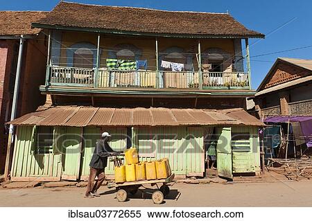 "Man pushing goods on home-made cart, French colonial architecture, Ambalavao, Madagascar, Africa" View Large Photo Image Stock Photography - "Man pushing goods on home-made cart, French colonial architecture, Ambalavao, Madagascar, Africa". Fotosearch