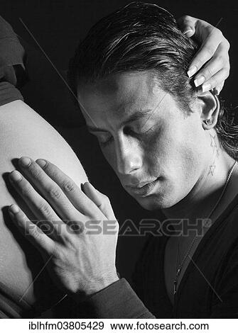 "Man putting his hand on the belly of a very pregnant woman, Germany, Europe" View Large Photo Image Stock Photo - "Man putting his hand on the belly of a very pregnant woman, Germany, Europe". Fotosearch