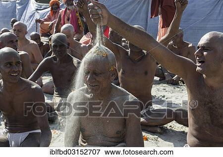 "Man putting sand on the head of a another man joining the initiation of new sadhus, during Kumbha Mela festival, Allahabad, Uttar Pradesh, India, Asia" View Large Photo Image Stock Photo - "Man putting sand on the head of a another man joining the initiation of new sadhus, during Kumbha Mela festival, Allahabad, Uttar Pradesh, India, Asia". Fotosearch