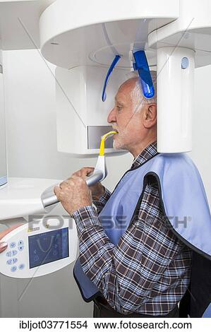 "Man receiving an X-ray of his teeth, wearing a lead vest for protection from radiation, Germany, Europe" View Large Photo Image Picture - "Man receiving an X-ray of his teeth, wearing a lead vest for protection from radiation, Germany, Europe". Fotosearch