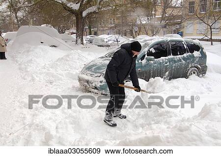 "Man removing snow from car, Odessa, Odessa Oblast, Ukraine, Europe" View Large Photo Image Stock Photo - "Man removing snow from car, Odessa, Odessa Oblast, Ukraine, Europe". Fotosearch