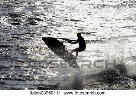 "Man riding a water scooter in backlight, Ystad, Scania, Sweden, Europe" View Large Photo Image Stock Image - "Man riding a water scooter in backlight, Ystad, Scania, Sweden, Europe". Fotosearch