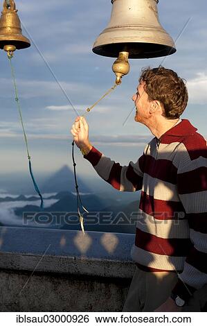 "Man ringing a bell at a Buddhist temple, Adam's Peak, Sri Pada, Dalhousie, Zentrales Hochland, Sri Lanka, Asia" View Large Photo Image Stock Photograph - "Man ringing a bell at a Buddhist temple, Adam's Peak, Sri Pada, Dalhousie, Zentrales Hochland, Sri Lanka, Asia". Fotosearch