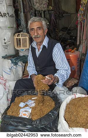 Stock Image - "Man selling tobacco, Mardin market, Anatolia, Eastern Turkey". Fotosearch