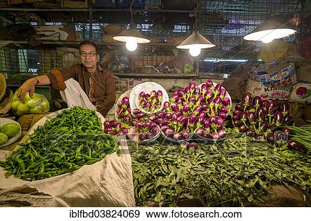 Stock Photo - "Man selling vegetables at a vegetable market, Bhavnagar, Gujarat, India, Asia". Fotosearch