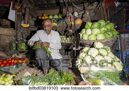 Stock Image - "Man selling vegetables at Crawfort Market, Mumbai, Maharashtra, India, Asia". Fotosearch