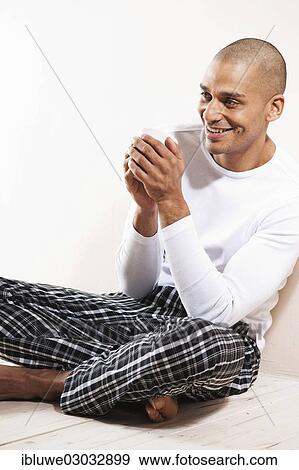 "Man sitting comfortably at home, with a cup of tea, Mannheim, Baden-Wurttemberg, Germany, Europe" View Large Photo Image Stock Photo - "Man sitting comfortably at home, with a cup of tea, Mannheim, Baden-Wurttemberg, Germany, Europe". Fotosearch
