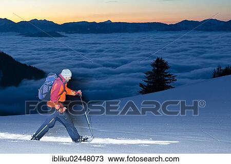 "Man snowshoeing, snowshoe hike at Ahornkaser on the Rossfeldstrasse, looking towards Watzmann Mountain, Berchtesgadener Land, Bavaria, Germany, Europe" View Large Photo Image Stock Image - "Man snowshoeing, snowshoe hike at Ahornkaser on the Rossfeldstrasse, looking towards Watzmann Mountain, Berchtesgadener Land, Bavaria, Germany, Europe". Fotosearch