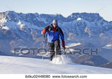 "Man snowshoeing, snowshoe tour in Berchtesgadener Land, Unterberg mountain and Hochthron mountain at the back, Berchtesgadener Land, Bavaria, Germany, Europe" View Large Photo Image Stock Image - "Man snowshoeing, snowshoe tour in Berchtesgadener Land, Unterberg mountain and Hochthron mountain at the back, Berchtesgadener Land, Bavaria, Germany, Europe". Fotosearch