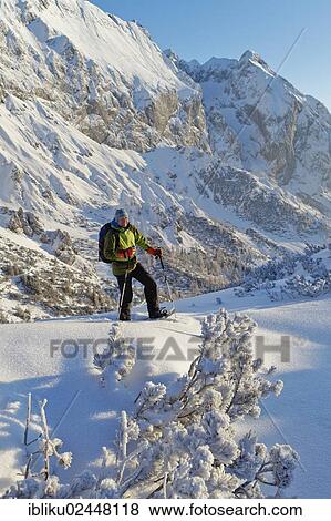 "Man snowshoeing, snowshoe tour on Torrener Joch pass, border Salzburg - Berchtesgaden, looking towards Hohes Brett mountain, Berchtesgadener Land, Bavaria, Germany, Europe" View Large Photo Image Stock Photo - "Man snowshoeing, snowshoe tour on Torrener Joch pass, border Salzburg - Berchtesgaden, looking towards Hohes Brett mountain, Berchtesgadener Land, Bavaria, Germany, Europe". Fotosearch