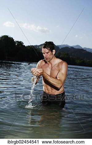 "Man standing in a lake in Sonthofen, Allgaeu, Bavaria, Germany, Europe" View Large Photo Image Stock Image - "Man standing in a lake in Sonthofen, Allgaeu, Bavaria, Germany, Europe". Fotosearch