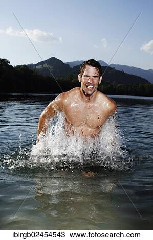 "Man standing in a lake in Sonthofen, Allgaeu, Bavaria, Germany, Europe" View Large Photo Image Stock Image - "Man standing in a lake in Sonthofen, Allgaeu, Bavaria, Germany, Europe". Fotosearch