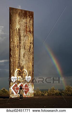 "Man standing in front of the steel slab on Schurenbachhalde, a former spoil tip, with a rainbow, Essen, North Rhine-Westphalia, Germany, Europe, PublicGround, Europe" View Large Photo Image Stock Image - "Man standing in front of the steel slab on Schurenbachhalde, a former spoil tip, with a rainbow, Essen, North Rhine-Westphalia, Germany, Europe, PublicGround, Europe". Fotosearch