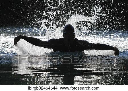 "Man swimming with a butterfly stroke in a lake in Sonthofen, Allgaeu, Bavaria, Germany, Europe" View Large Photo Image Picture - "Man swimming with a butterfly stroke in a lake in Sonthofen, Allgaeu, Bavaria, Germany, Europe". Fotosearch
