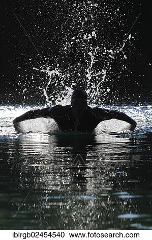 "Man swimming with a butterfly stroke in a lake in Sonthofen, Allgaeu, Bavaria, Germany, Europe" View Large Photo Image Stock Image - "Man swimming with a butterfly stroke in a lake in Sonthofen, Allgaeu, Bavaria, Germany, Europe". Fotosearch