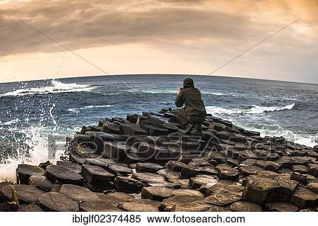 "Man taking photo with a smartphone, Giant's Causeway, basalt columns, Causeway Coast, County Antrim, Northern Ireland, United Kingdom, Europe" View Large Photo Image Stock Photography - "Man taking photo with a smartphone, Giant's Causeway, basalt columns, Causeway Coast, County Antrim, Northern Ireland, United Kingdom, Europe". Fotosearch