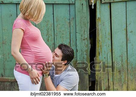 Man tenderly kissing the belly of a pregnant woman View Large Photo Image Stock Photography - Man tenderly kissing the belly of a pregnant woman. Fotosearch