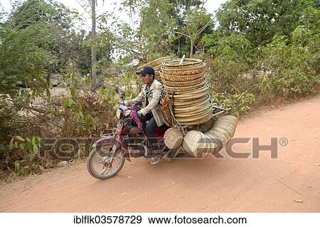 "Man transporting baskets by motorbike to the market, Bathi District, Takeo Province, Cambodia, Asia" View Large Photo Image Stock Photo - "Man transporting baskets by motorbike to the market, Bathi District, Takeo Province, Cambodia, Asia". Fotosearch