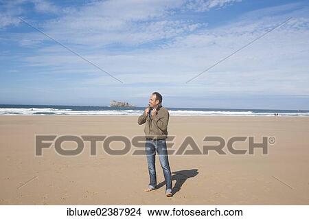 Man walking along the beach View Large Photo Image Picture - Man walking along the beach. Fotosearch