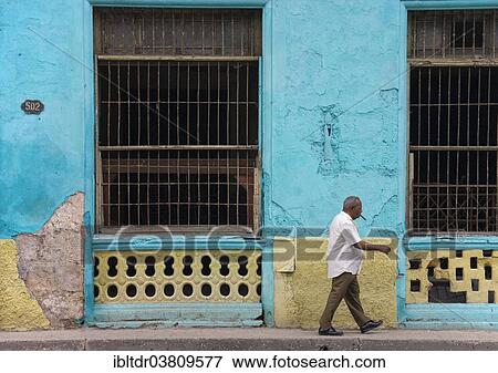 "Man walking past a run down bulding, Havana, Cuba, North America" View Large Photo Image Stock Photo - "Man walking past a run down bulding, Havana, Cuba, North America". Fotosearch
