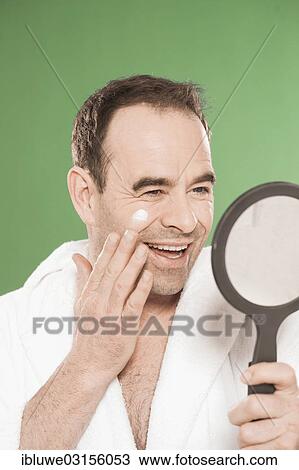 "Man wearing a bathrobe looking at himself in a hand mirror, Mannheim, Baden-Wurttemberg, Germany, Europe" View Large Photo Image Stock Image - "Man wearing a bathrobe looking at himself in a hand mirror, Mannheim, Baden-Wurttemberg, Germany, Europe". Fotosearch