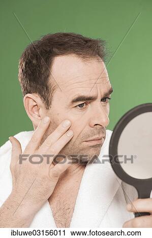 "Man wearing a bathrobe observing himself critically in a hand mirror, Mannheim, Baden-Wurttemberg, Germany, Europe" View Large Photo Image Stock Image - "Man wearing a bathrobe observing himself critically in a hand mirror, Mannheim, Baden-Wurttemberg, Germany, Europe". Fotosearch