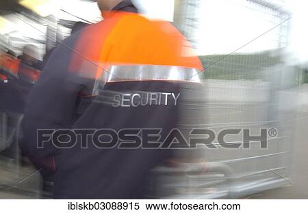 "Man wearing a security jacket, blurred from behind" View Large Photo Image Stock Photography - "Man wearing a security jacket, blurred from behind". Fotosearch