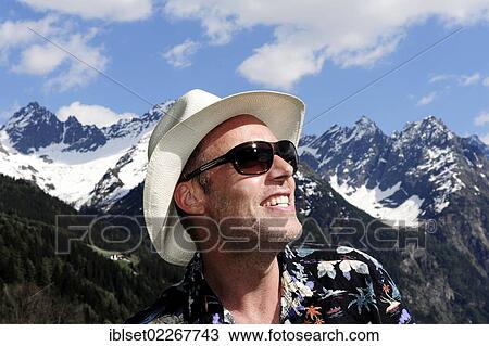 "Man wearing a straw hat and sunglasses, Tyrolean mountains, Kaunertal, Tyrol, Austria, Europe" View Large Photo Image Stock Image - "Man wearing a straw hat and sunglasses, Tyrolean mountains, Kaunertal, Tyrol, Austria, Europe". Fotosearch