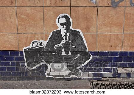 "Man wearing a suit, banker or businessman with a briefcase, poster glued on a wall, Berlin, Germany, Europe" View Large Photo Image Stock Image - "Man wearing a suit, banker or businessman with a briefcase, poster glued on a wall, Berlin, Germany, Europe". Fotosearch