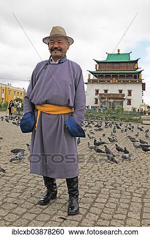 "Man wearing a traditional deel in front of Migjed Janraisig Temple in the Buddhist Gandan Monastery, Ulaanbaatar, Mongolia, Asia" View Large Photo Image Stock Image - "Man wearing a traditional deel in front of Migjed Janraisig Temple in the Buddhist Gandan Monastery, Ulaanbaatar, Mongolia, Asia". Fotosearch