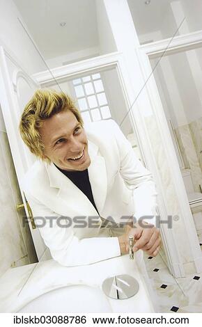 Man wearing a white suit snorting cocaine with a rolled bill View Large Photo Image Stock Photograph - Man wearing a white suit snorting cocaine with a rolled bill. Fotosearch