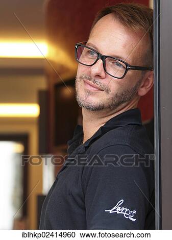 Man wearing glasses, dreamy look, portrait View Large Photo Image Stock Image - Man wearing glasses, dreamy look, portrait. Fotosearch