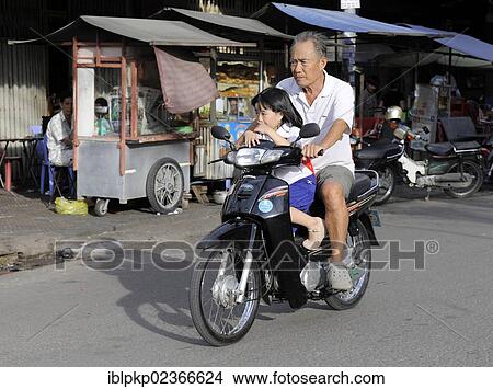 "Man with a child on a motor scooter, Phnom Penh, Cambodia, Southeast Asia, Asia" View Large Photo Image Picture - "Man with a child on a motor scooter, Phnom Penh, Cambodia, Southeast Asia, Asia". Fotosearch