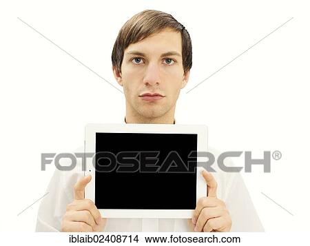 Picture - Man with a serious face holding an iPad. Fotosearch