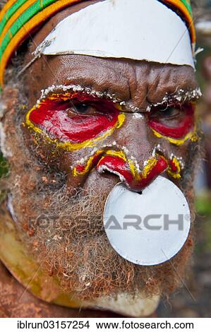 "Man with colourful decorations and face paint is celebrating at the traditional Sing Sing gathering in the Highlands, Paya, Papua New Guinea, Oceania" View Large Photo Image Picture - "Man with colourful decorations and face paint is celebrating at the traditional Sing Sing gathering in the Highlands, Paya, Papua New Guinea, Oceania". Fotosearch
