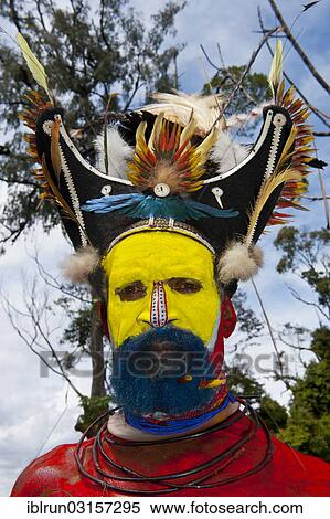 "Man with colourful decorations and face paint is celebrating at the traditional Sing Sing gathering in the highlands, Paya, Papua New Guinea, Oceania" View Large Photo Image Stock Photography - "Man with colourful decorations and face paint is celebrating at the traditional Sing Sing gathering in the highlands, Paya, Papua New Guinea, Oceania". Fotosearch