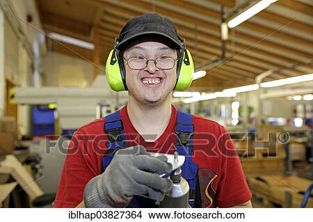 Man with Down syndrome at work View Large Photo Image Picture - Man with Down syndrome at work. Fotosearch