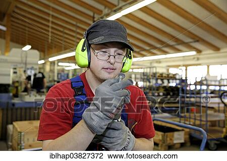 Man with Down syndrome at work View Large Photo Image Stock Image - Man with Down syndrome at work. Fotosearch
