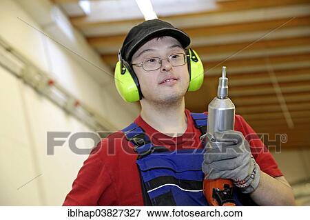 Man with Down syndrome at work View Large Photo Image Stock Photo - Man with Down syndrome at work. Fotosearch