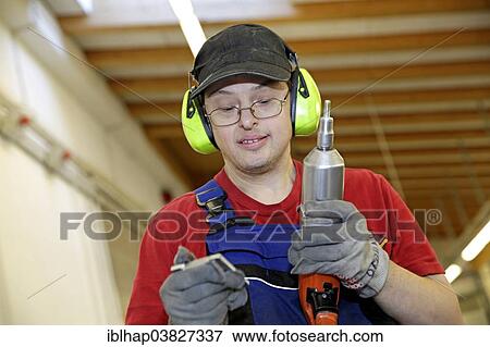 Man with Down syndrome at work View Large Photo Image Stock Photo - Man with Down syndrome at work. Fotosearch