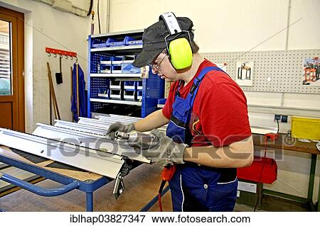 Stock Photo - Man with Down syndrome at work. Fotosearch