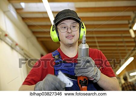 Man with Down syndrome at work View Large Photo Image Stock Photograph - Man with Down syndrome at work. Fotosearch