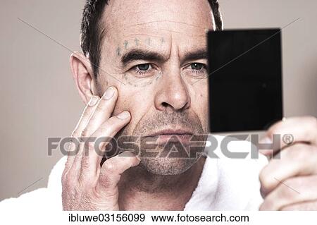 Stock Photo - "Man with markings for plastic surgery on his face, Mannheim, Baden-Wurttemberg, Germany, Europe". Fotosearch